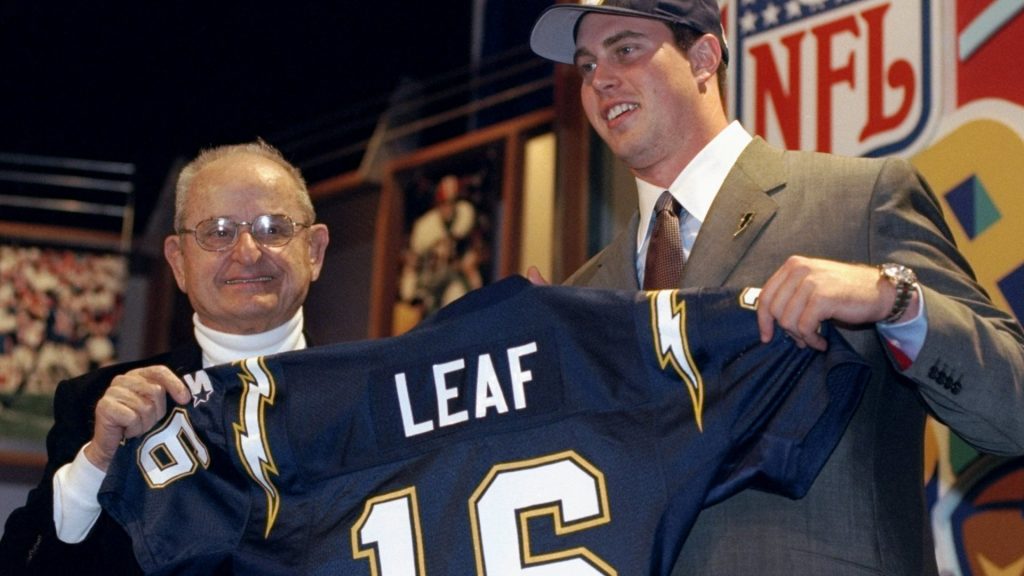 A photo of Ryan Leaf holding up an NFL jersey