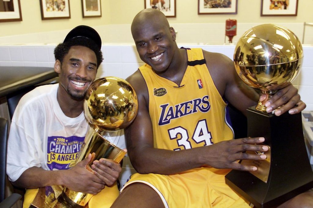 A young Kobe and Shaq posing with their trophies