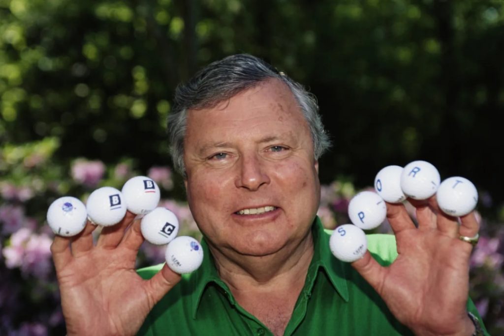 Peter Alliss holding up BBC Sport golf balls