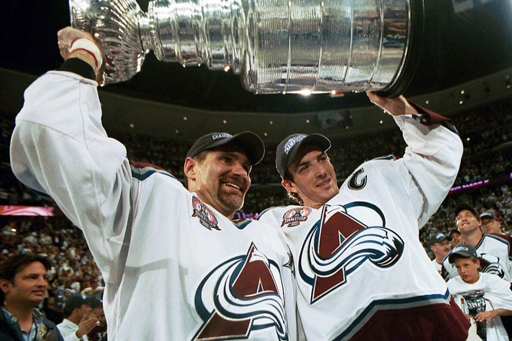 Two Colorado Avalanche skaters lift the 2001 Stanley Cup