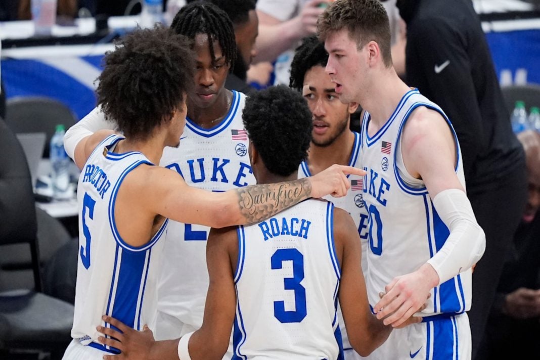 The Duke Blue Devils have a team huddle on the court