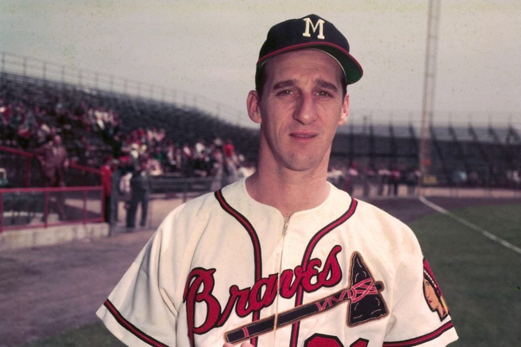 Warren Spahn stands in front of the crowd at a Braves game