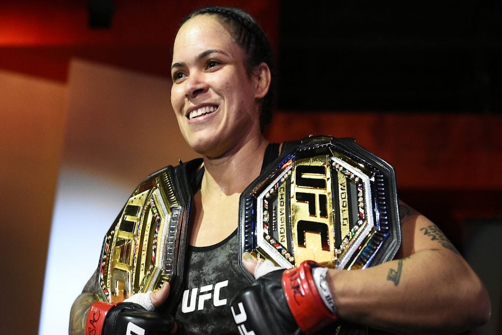 The best UFC fighter in women's history Amanda Nunes holding two belts