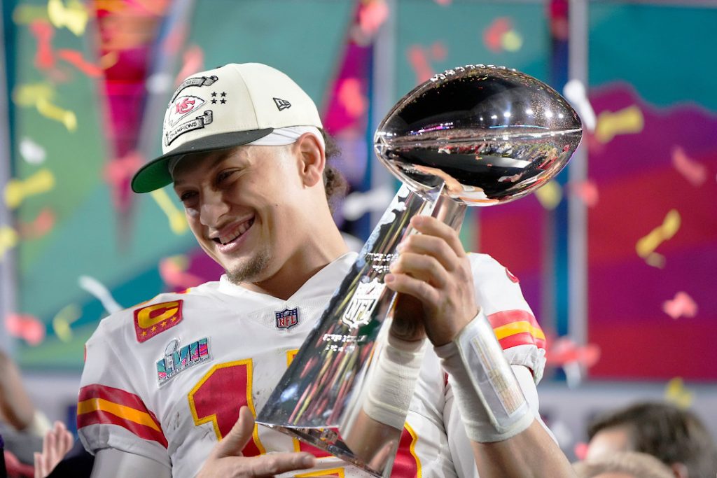 Patrick Mahomes celebrating with the Super Bowl trophy
