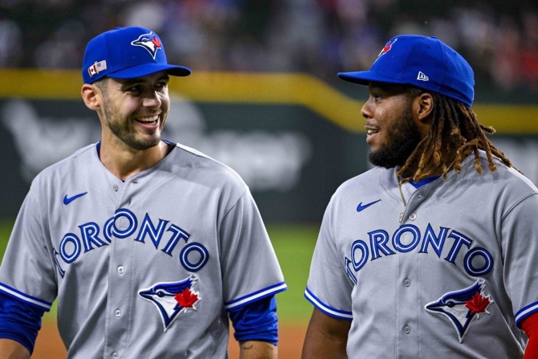 Two Toronto Blue Jays players talking on the field