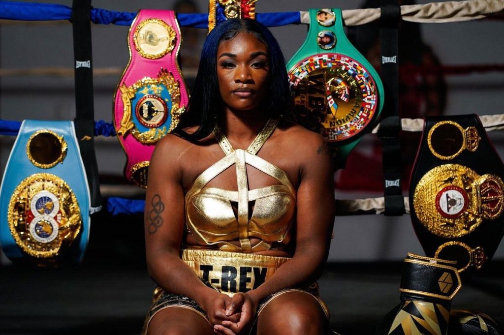 Claressa Shields posing with her belts