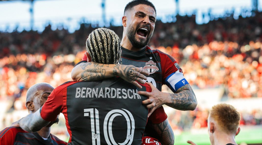 Lorenzo Insigne celebrates with Federico Bernardeschi.