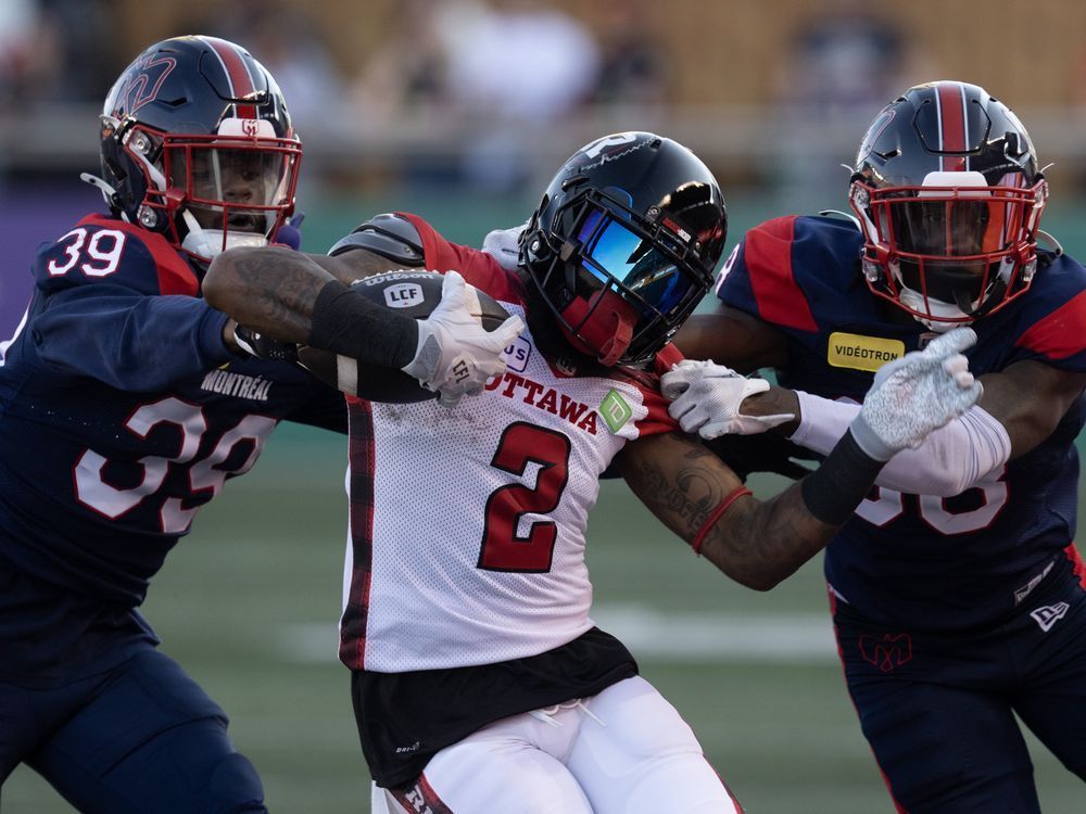 Alouettes defenders take down a running back